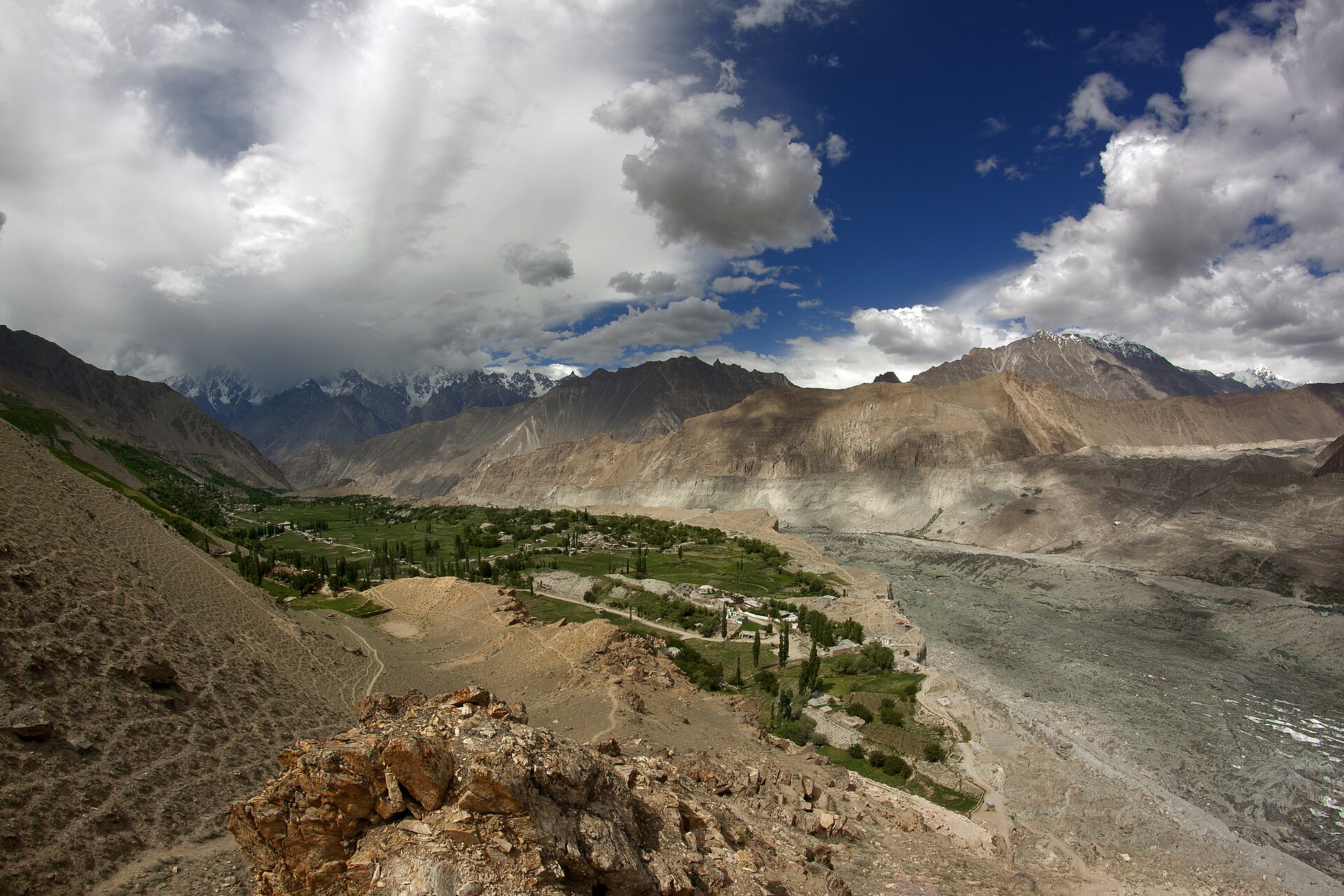 Hopar valley in Nagar district, a village on the valley floor below grey peaks